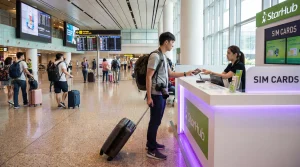 Tourist buying prepaid SIM card at Singapore Changi Airport