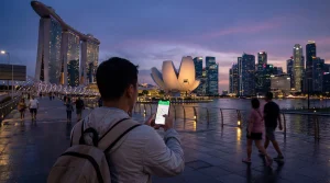 Tourist using smartphone with mobile internet at Marina Bay Singapore