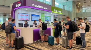 Tourists buying prepaid SIM cards at Singapore Changi Airport arrivals hall
