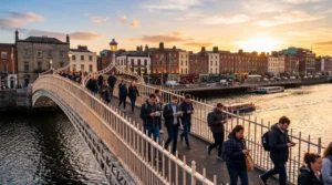tourists using smartphones with mobile internet near hapenny bridge dublin