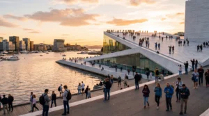 tourists using smartphones with mobile internet near oslo opera house waterfront