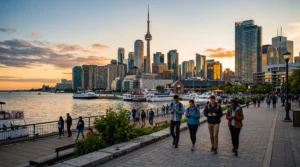 tourists using smartphones with mobile internet near cn tower toronto