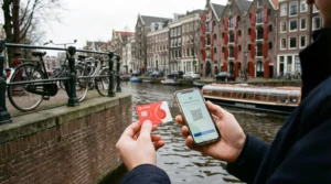 Tourist comparing local SIM card and eSIM on smartphone near canal in Amsterdam Netherlands.
