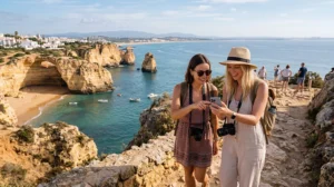 Tourists using mobile internet and Portugal eSIM while exploring Algarve beaches
