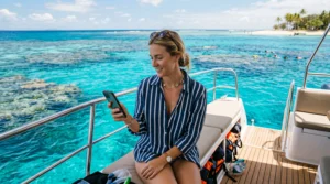 Tourist using mobile internet while visiting the Great Barrier Reef in Australia