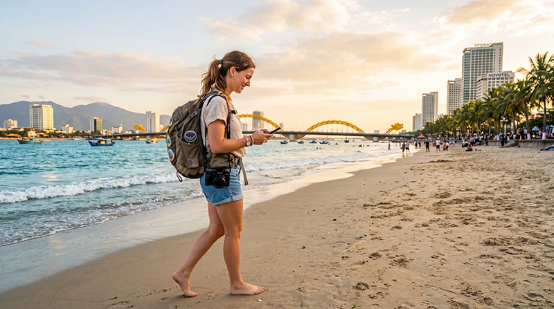 Tourist using eSIM mobile internet while exploring Da Nang beach and city in Vietnam