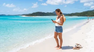 Traveler using an eSIM while exploring the Whitsundays and Whitehaven Beach in Australia