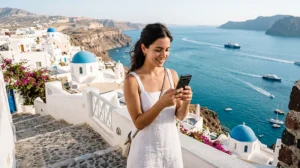 Traveler in Greece checking mobile data near the Aegean Sea and ferry port