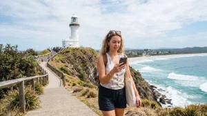 Tourist using mobile internet while exploring Byron Bay in Australia