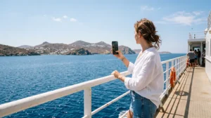 Traveler using mobile internet while traveling on a Greek ferry