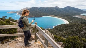Tourist using mobile internet while exploring Tasmania Australia