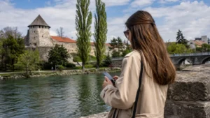 Traveller using a smartphone during mobile internet in banja luka in Bosnia and Herzegovina.