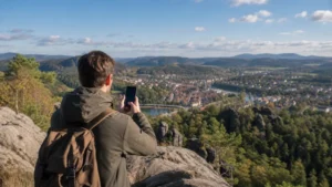 Traveller checking mobile signal at a viewpoint in the Czech Republic.