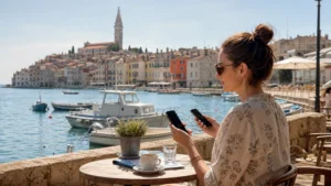Traveller comparing connectivity options at a waterfront café in Rovinj.