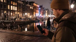 Electronic music fan using mobile internet while attending Amsterdam Dance Event