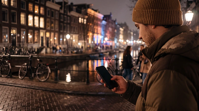 Electronic music fan using mobile internet while attending Amsterdam Dance Event