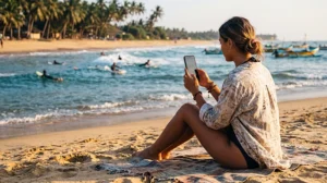 Tourist using mobile internet while visiting Arugam Bay on the east coast of Sri Lanka