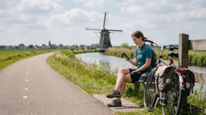 Cyclist using mobile internet while exploring the Netherlands by bicycle