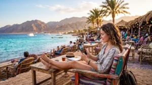 Tourist using mobile internet while visiting Dahab Egypt