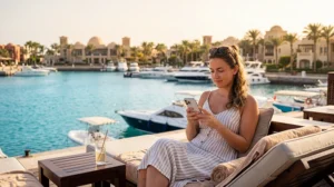 Tourist using mobile internet while visiting El Gouna Egypt