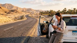Traveler using mobile internet during an Egypt road trip