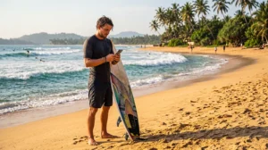 Surfer using mobile internet while travelling along the coast of Sri Lanka