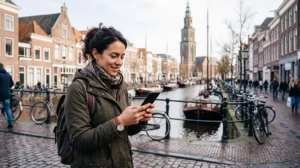 Tourist using mobile internet while exploring Groningen in the Netherlands