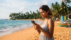 Tourist using mobile internet while visiting Hikkaduwa Beach in Sri Lanka