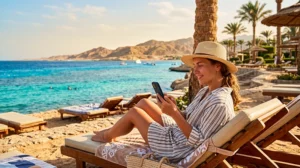 Tourist using mobile internet while visiting Makadi Bay Egypt