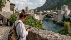 Traveller using a smartphone during internet in mostar for tourists in Bosnia and Herzegovina.
