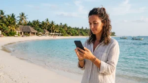 Tourist using mobile internet while relaxing on Pasikuda Beach in Sri Lanka