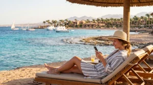 Tourist using mobile internet while visiting the Red Sea in Egypt