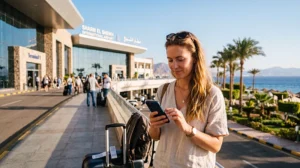 Tourist using mobile internet after arriving at Sharm El Sheikh International Airport
