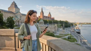Traveller using mobile internet beside the Szczecin waterfront.