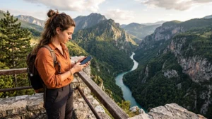 Traveler using mobile internet while visiting Tara Canyon in Montenegro