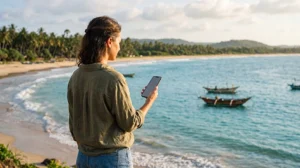 Tourist using mobile internet while exploring the coast near Trincomalee in Sri Lanka