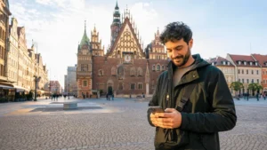 Traveller using mobile internet near Wrocław Market Square.
