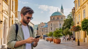 Traveller using a smartphone in central Pécs, Hungary
