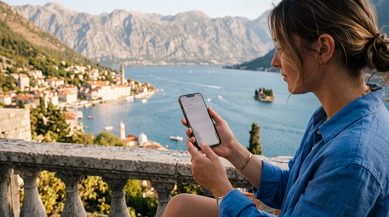 Traveler installing a Montenegro eSIM on an iPhone before traveling