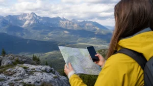 Tourist comparing an offline map and smartphone navigation at a Slovak scenic viewpoint.