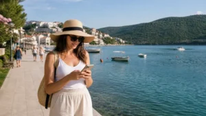 Traveller using a smartphone during mobile internet in neum in Bosnia and Herzegovina.