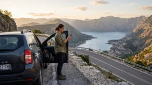 Traveler using mobile internet during a road trip in Montenegro