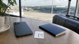 Smartphone and local SIM card on a table at Kraków Airport.