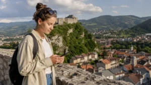 Traveller using a smartphone during mobile internet for a travnik day trip in Bosnia and Herzegovina.