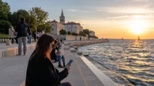 Traveller using a phone beside the Sea Organ in Zadar.