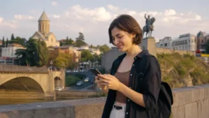 Traveller using a modern smartphone in contemporary Tbilisi