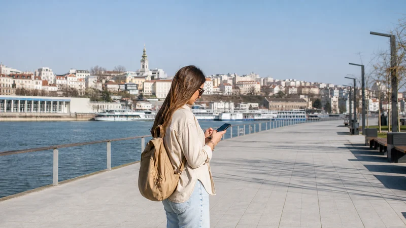 Traveller using a smartphone during 5g in serbia for tourists in Serbia.