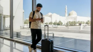 Traveller using a smartphone during activation at Muscat Airport arrivals