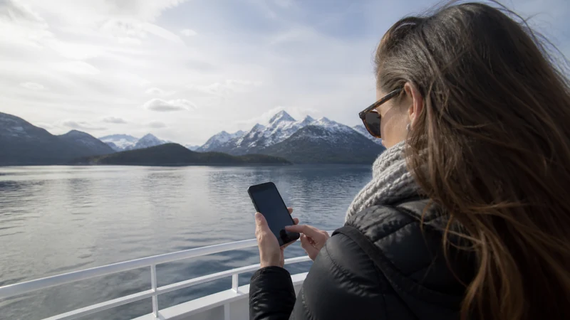Traveller using a smartphone in Argentina for can you rely on mobile data during argentina boat trips?