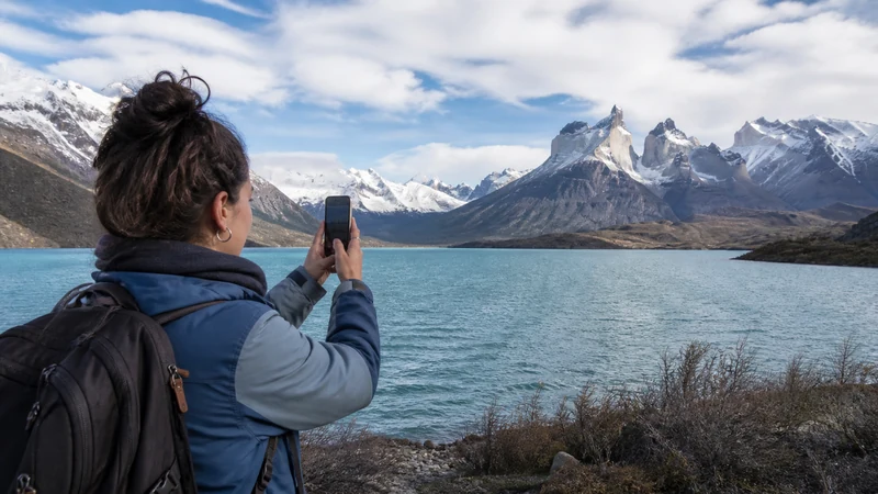 Traveller using a smartphone in Argentina for how to prepare your phone for an argentina road trip